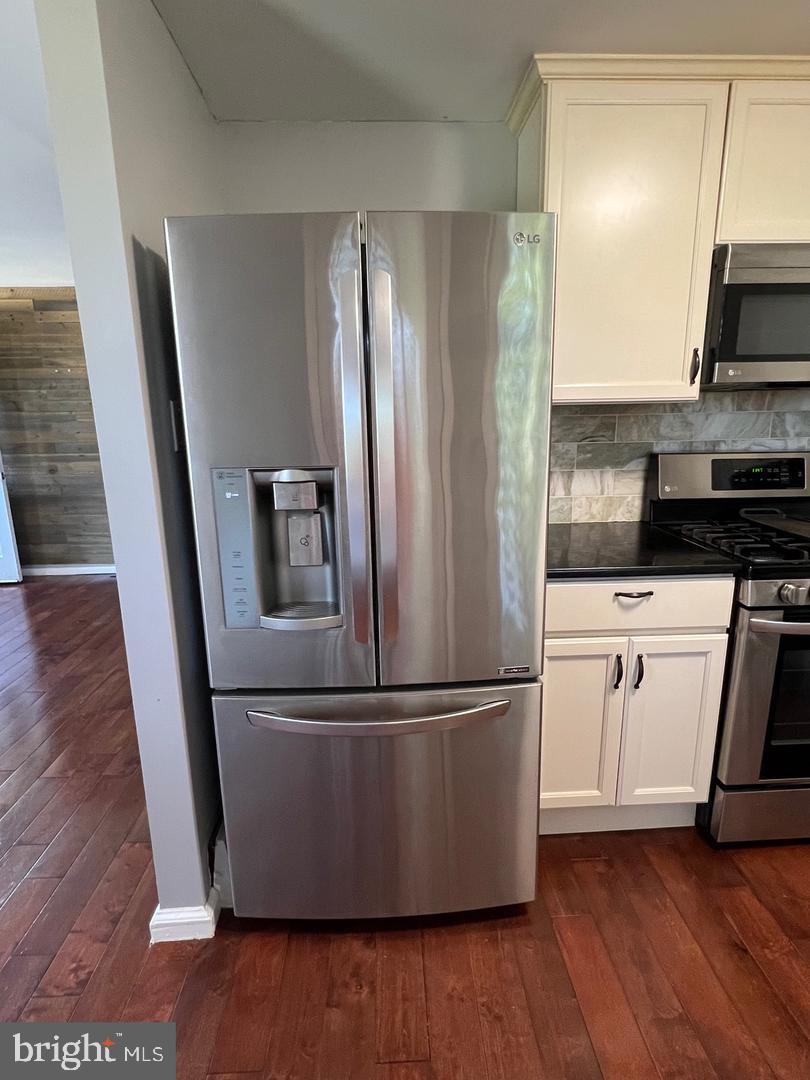 237 Miner Street Malvern, PA 19355 - Photo 11 of 28 a kitchen with wooden floors and stainless steel appliances