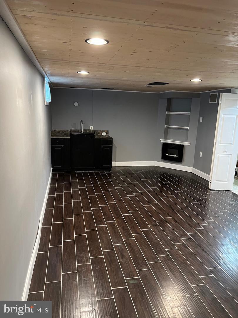 237 Miner Street Malvern, PA 19355 - Photo 22 of 28 an empty room with wooden floor a fireplace and window