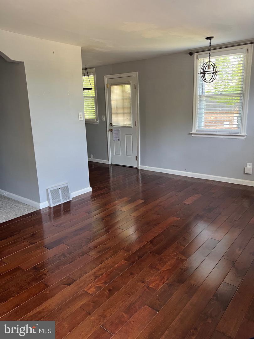 237 Miner Street Malvern, PA 19355 - Photo 6 of 28 an empty room with wooden floor and windows