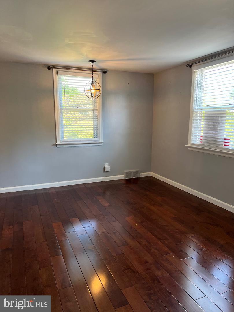 237 Miner Street Malvern, PA 19355 - Photo 7 of 28 an empty room with wooden floor and windows