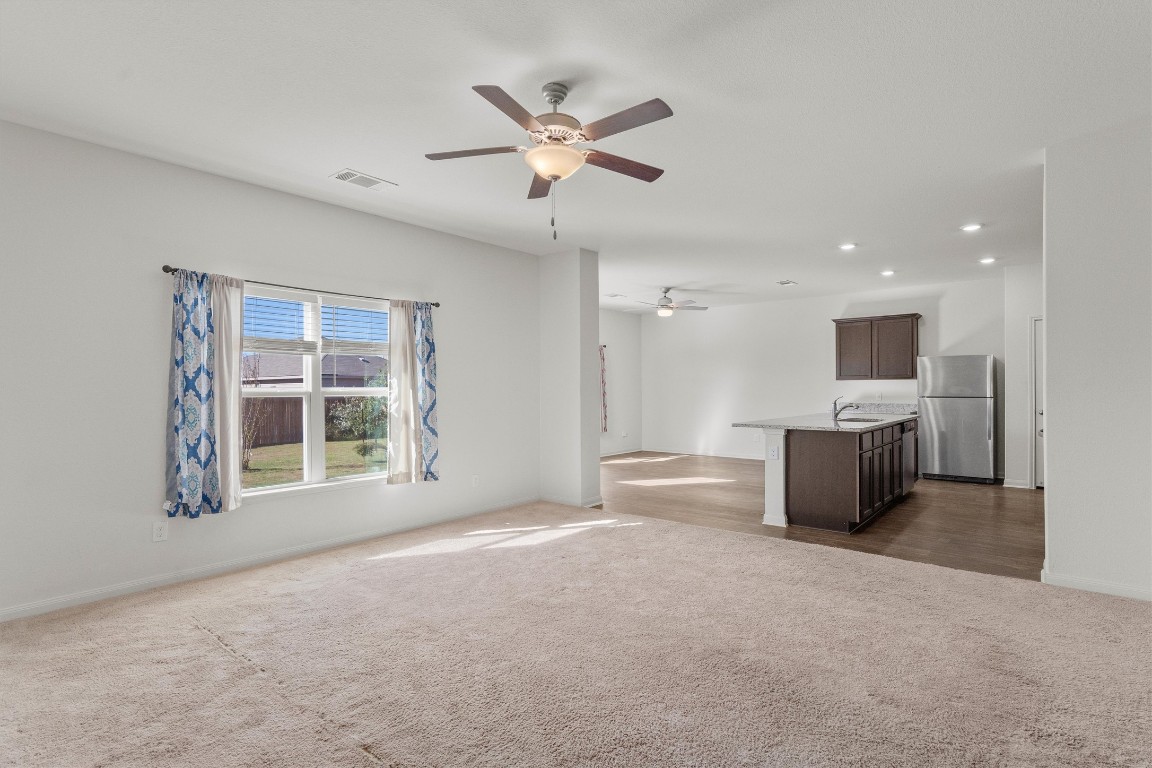 14405 Boomtown Way Elgin, TX 78621 - Photo 10 of 39 a view of an empty room with a window and a kitchen