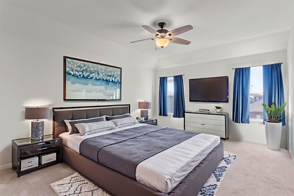 14405 Boomtown Way Elgin, TX 78621 - Photo 13 of 39 a bedroom with a bed and a flat screen tv