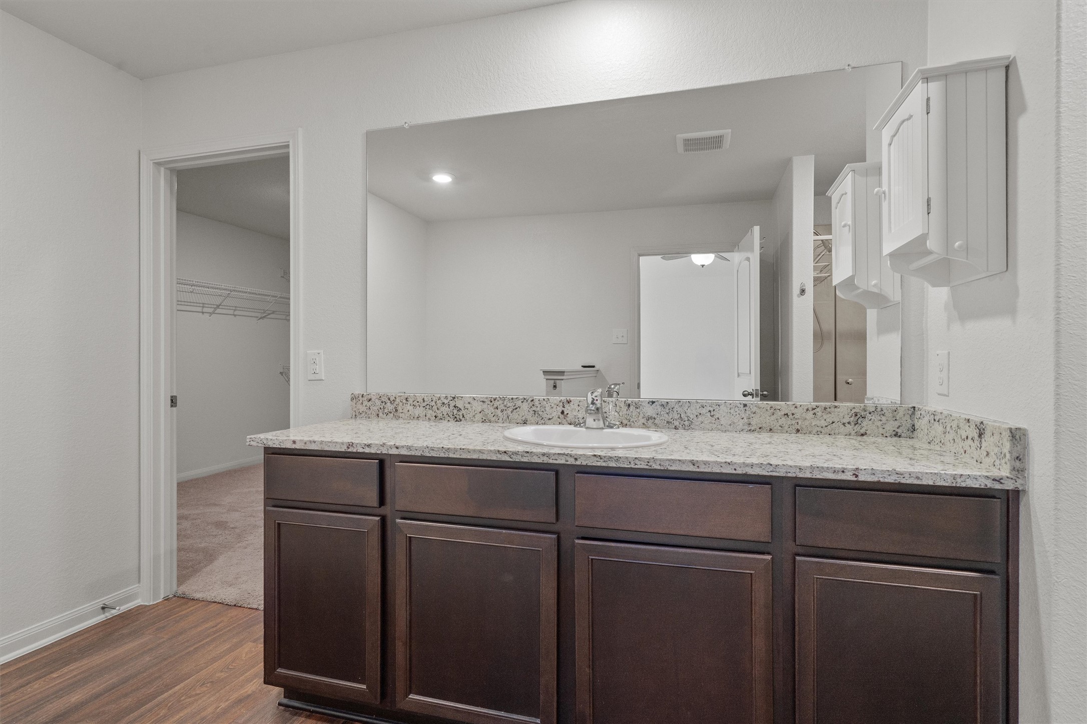 14405 Boomtown Way Elgin, TX 78621 - Photo 15 of 39 a bathroom with a granite countertop sink and a mirror