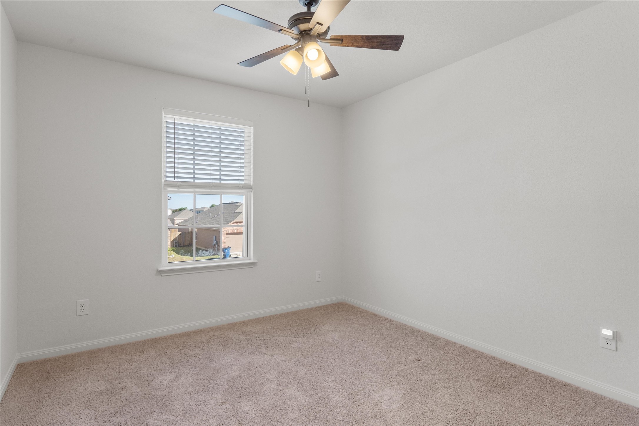14405 Boomtown Way Elgin, TX 78621 - Photo 21 of 39 an empty room with a window and a fan