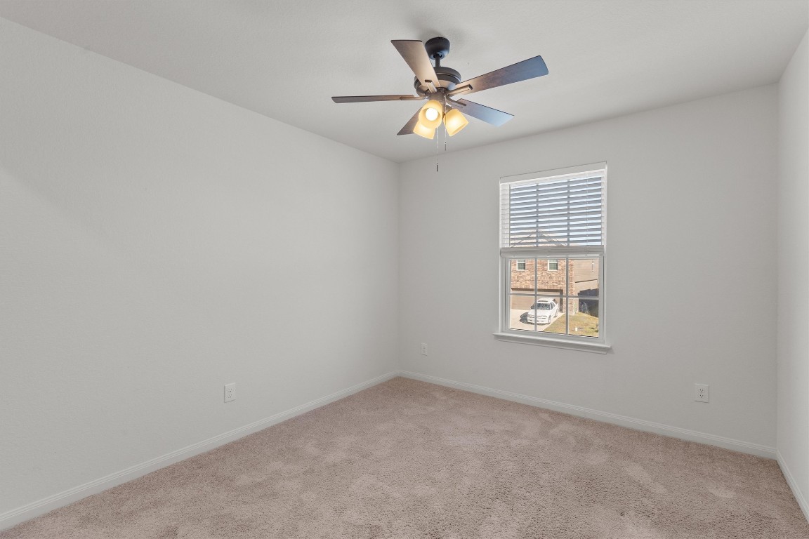 14405 Boomtown Way Elgin, TX 78621 - Photo 23 of 39 an empty room with windows and fan