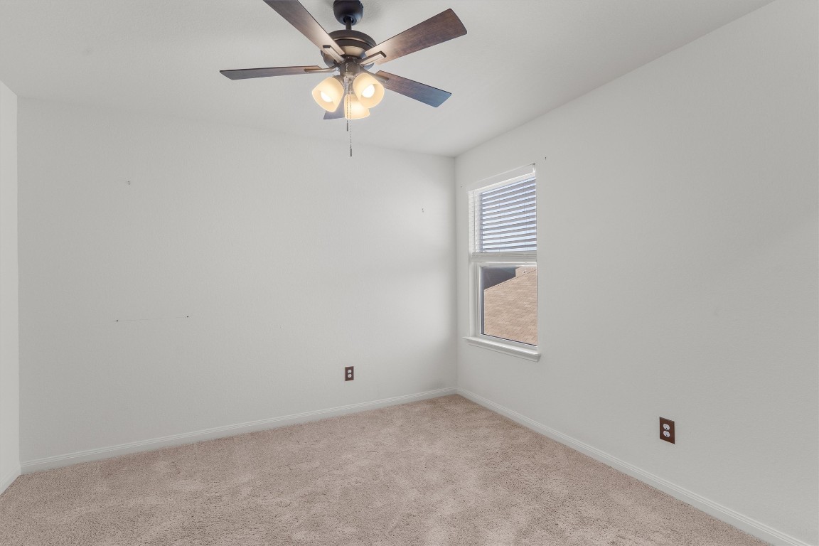 14405 Boomtown Way Elgin, TX 78621 - Photo 25 of 39 an empty room with windows and fan