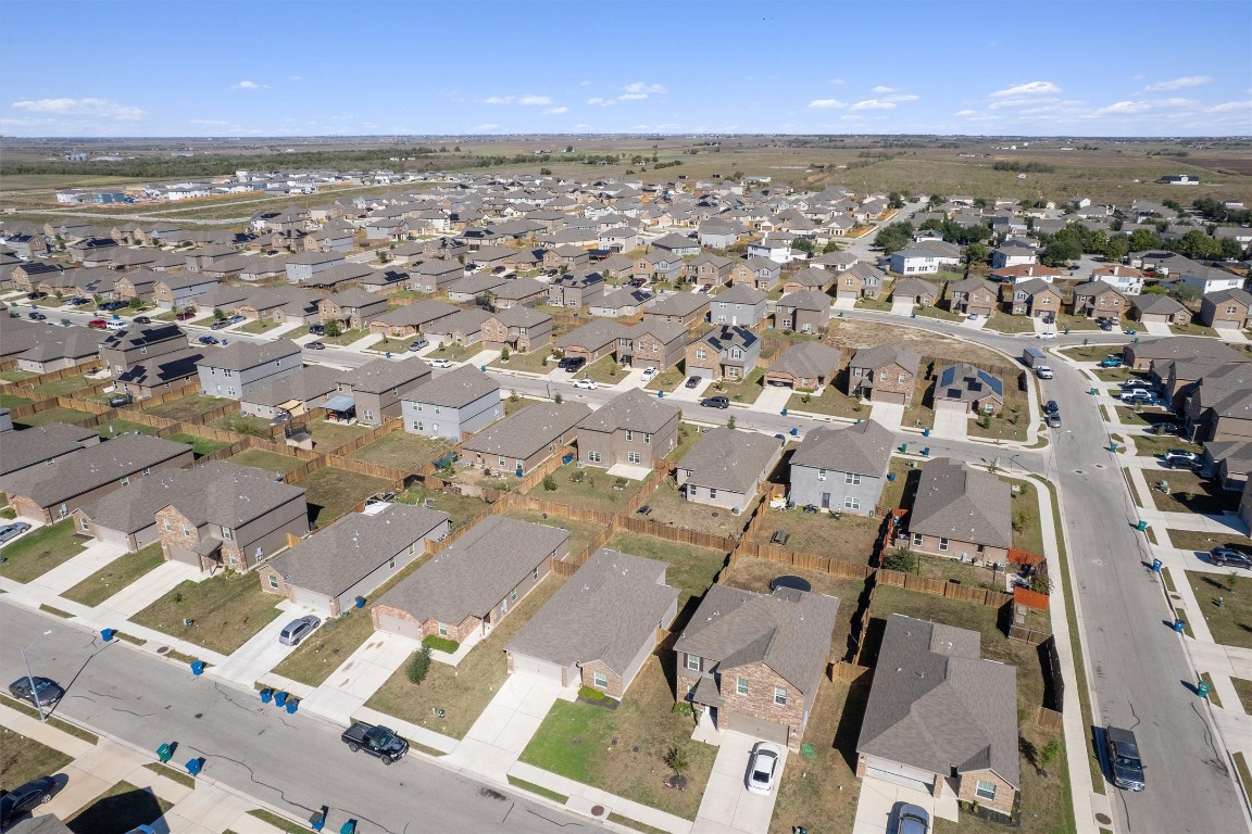 14405 Boomtown Way Elgin, TX 78621 - Photo 33 of 39 an aerial view of residential building with parking and yard