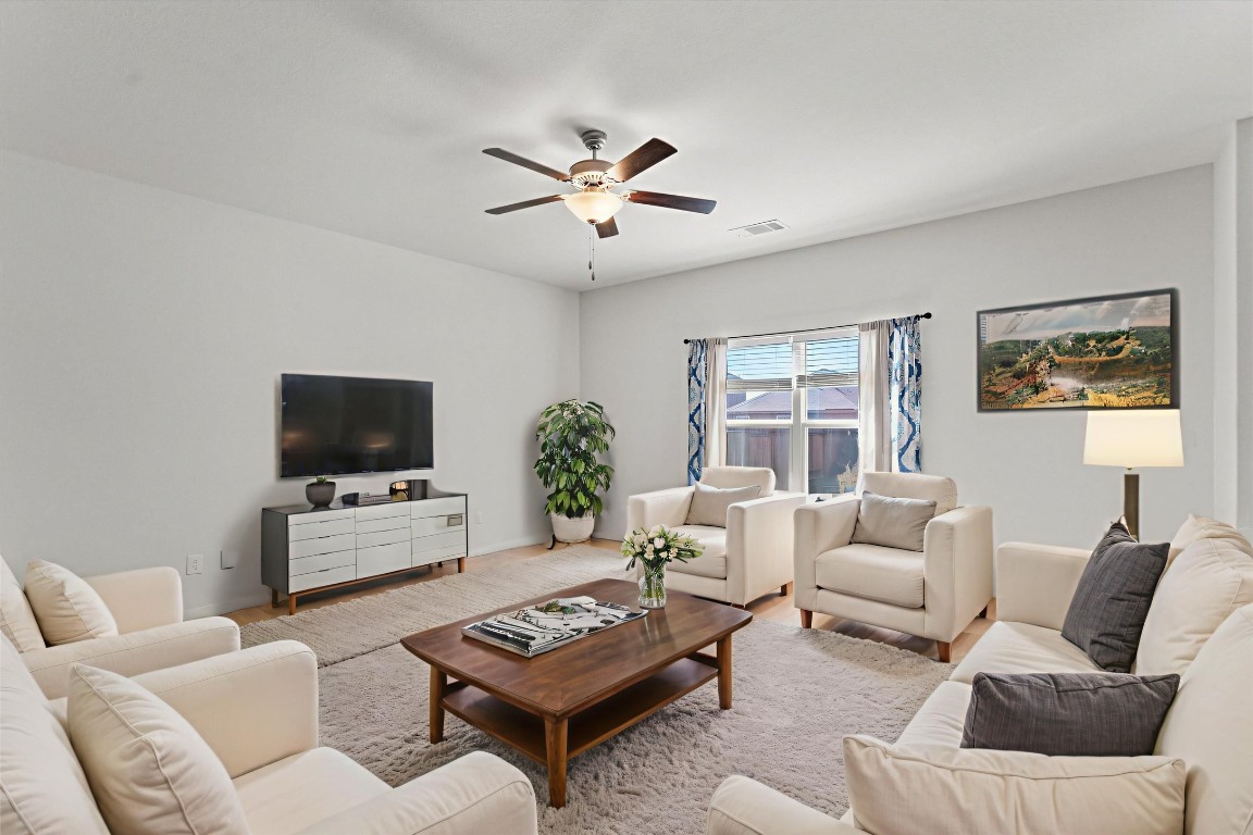 14405 Boomtown Way Elgin, TX 78621 - Photo 4 of 39 a living room with furniture a flat screen tv and a window