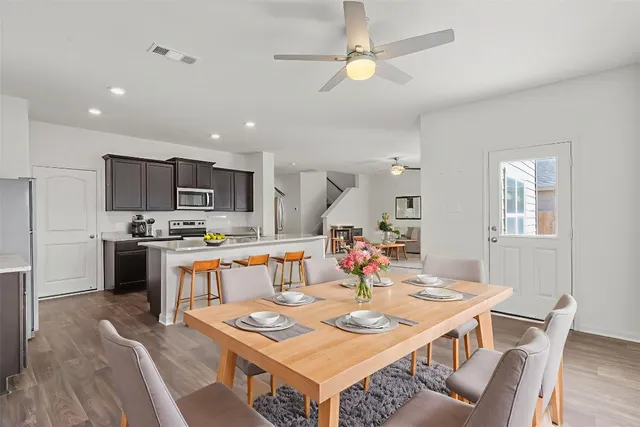 a large kitchen with a table and chairs