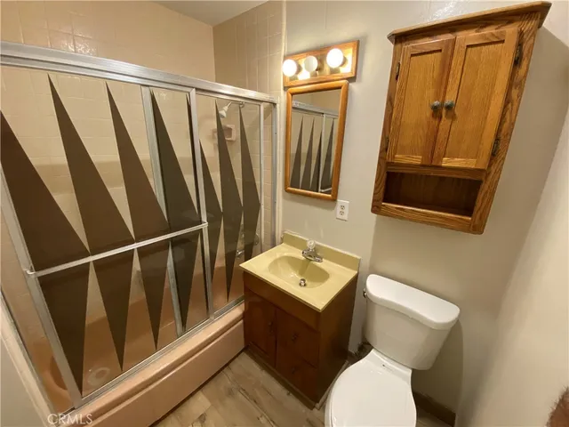 a bathroom with a sink a toilet and mirror