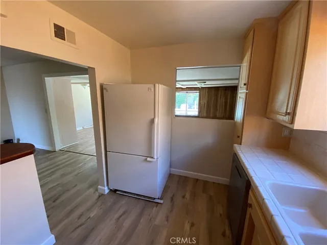 a kitchen with a refrigerator and a sink