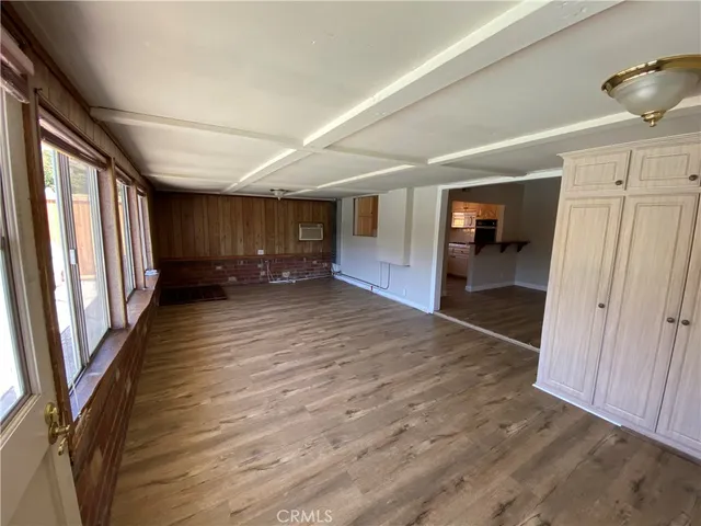 a view of a hallway with wooden floor and stairs