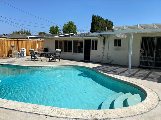 a view of a house with backyard porch and sitting area