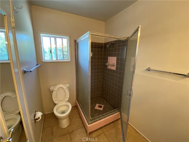a bathroom with a toilet and a shower