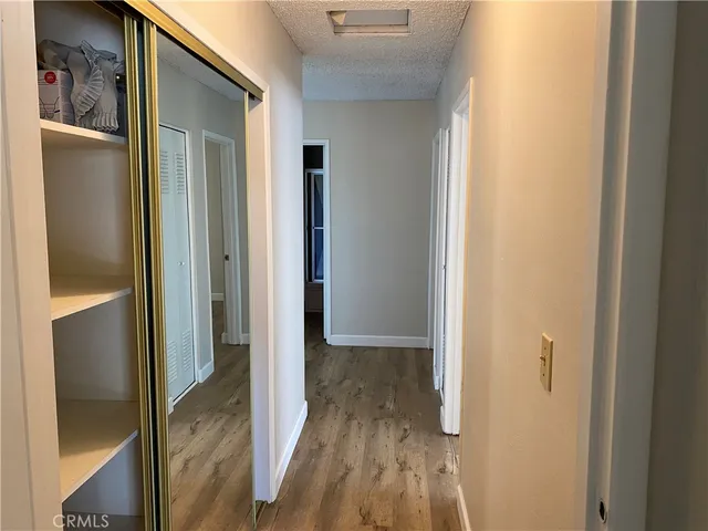 a view of hallway with wooden floor