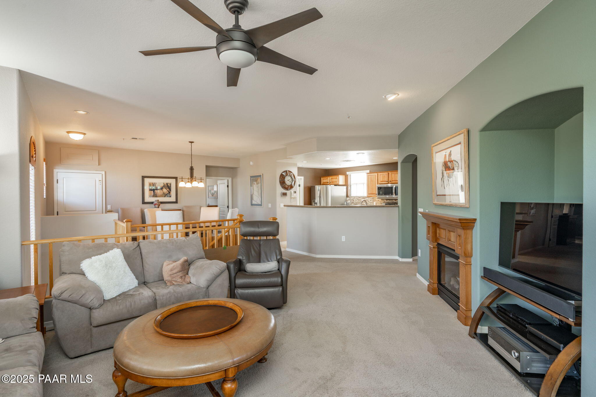 1716 Alpine Meadows Lane, Unit 305 Prescott, AZ 86303 - Photo 14 of 49 a living room with furniture a flat screen tv and kitchen view