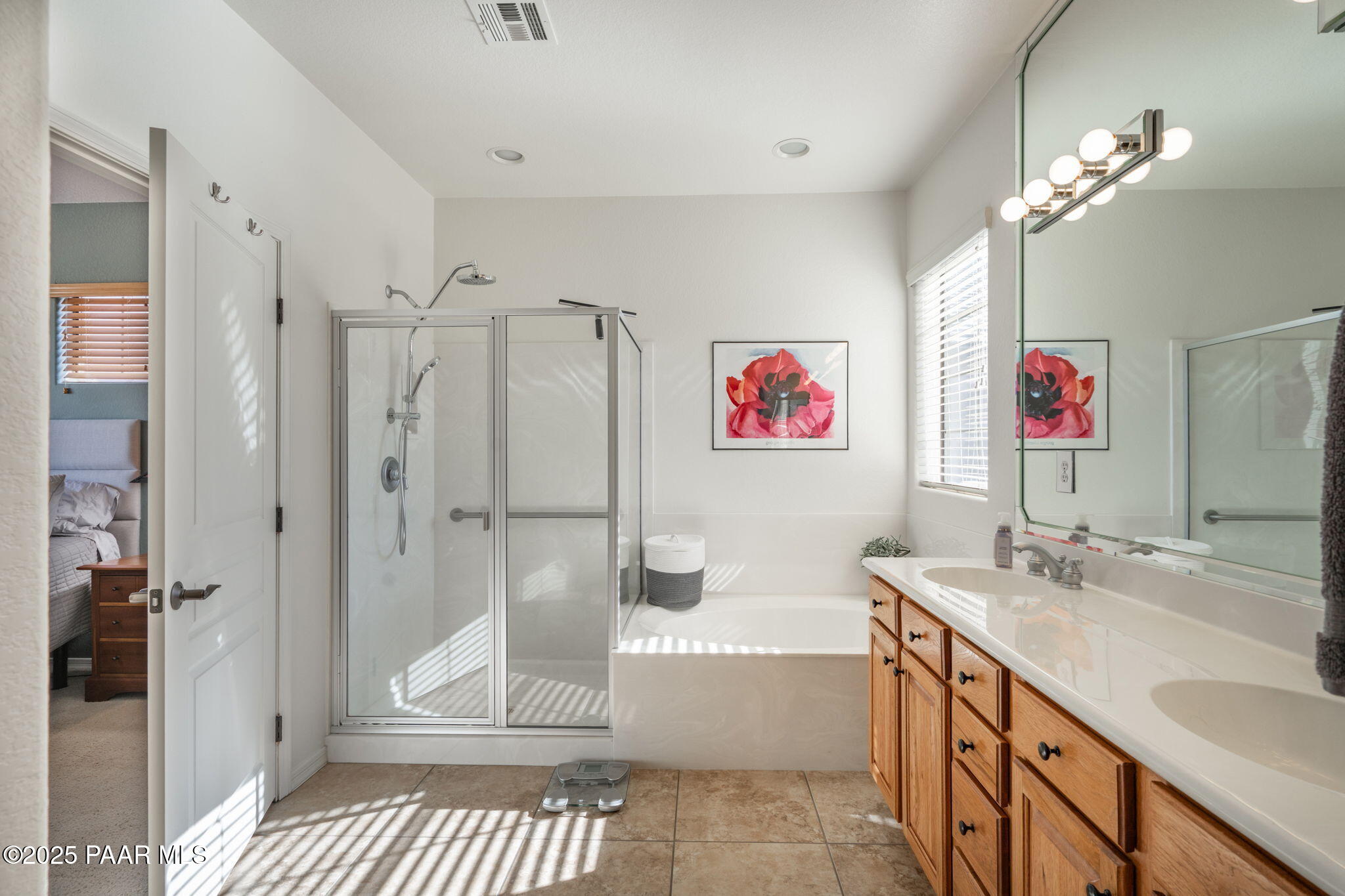 1716 Alpine Meadows Lane, Unit 305 Prescott, AZ 86303 - Photo 20 of 49 a spacious bathroom with a granite countertop tub sink a mirror and shower