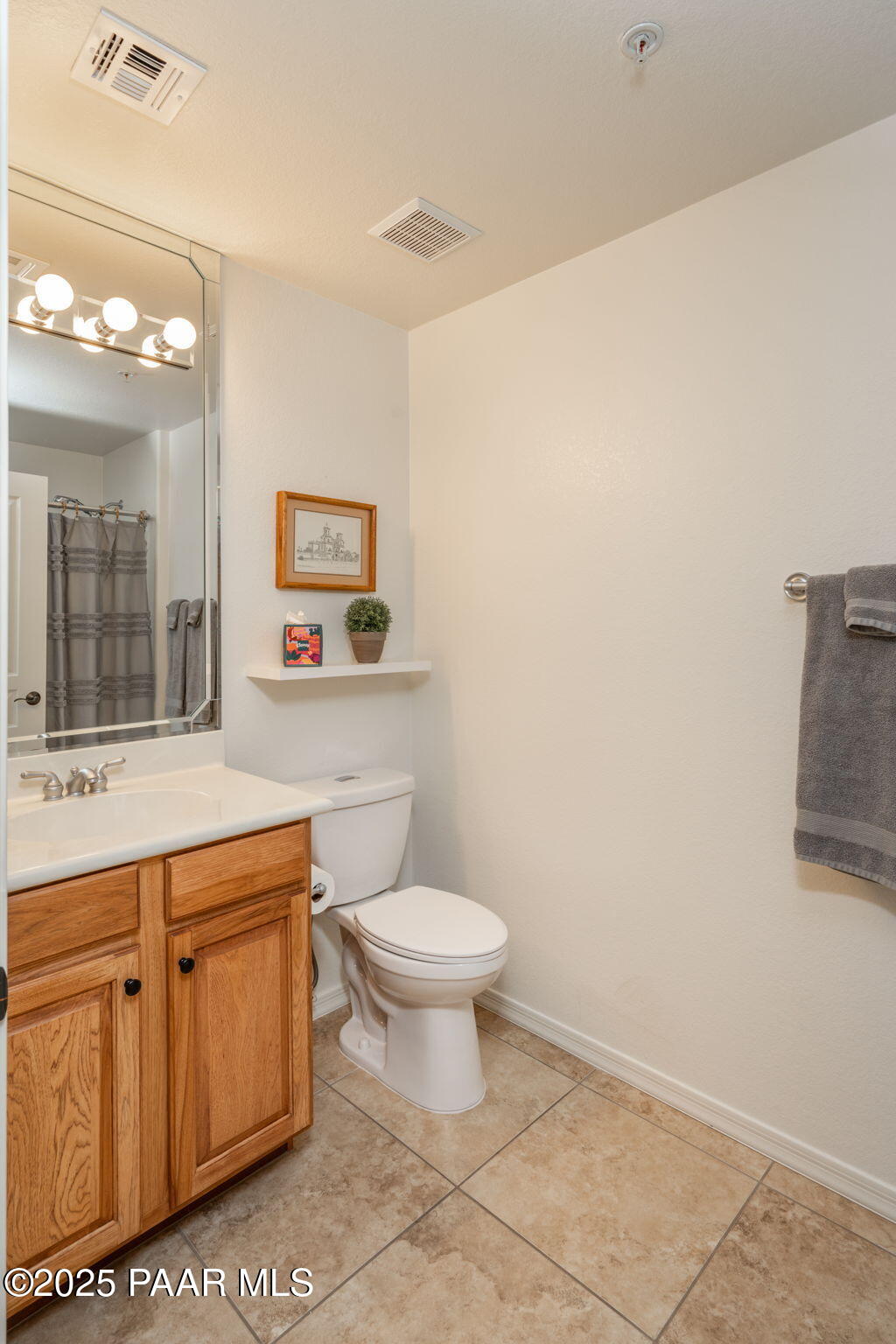 1716 Alpine Meadows Lane, Unit 305 Prescott, AZ 86303 - Photo 26 of 49 a bathroom with a toilet a sink and mirror