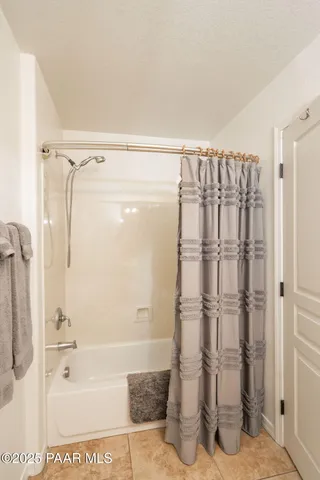 a bathroom with a shower and a glass door