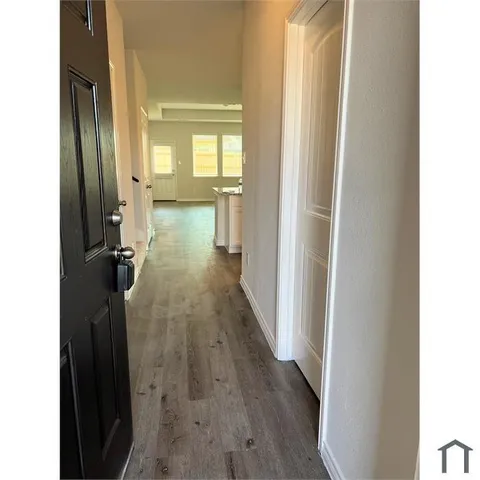 a view of hallway with wooden floor
