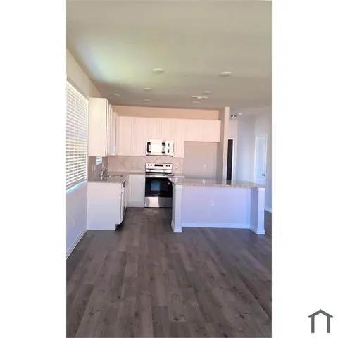 a kitchen with stainless steel appliances a sink and cabinets