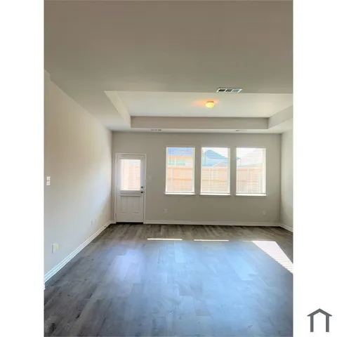 a view of room with hardwood floor and window