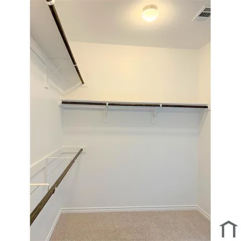 a view of staircase with white walls and a window