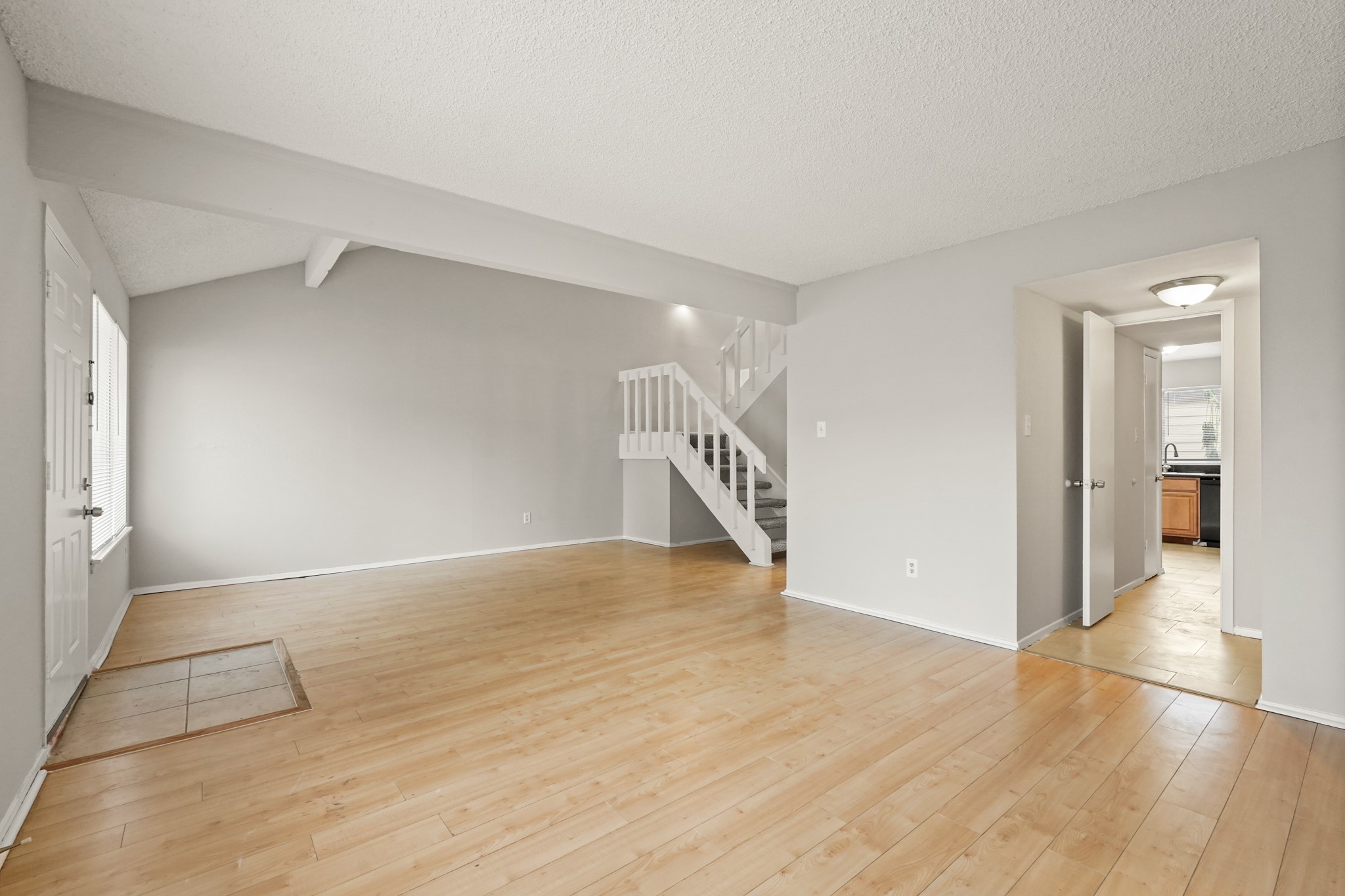 10328 Cook Road Houston, TX 77099 - Photo 3 of 16 a view of an empty room with wooden floor and a window