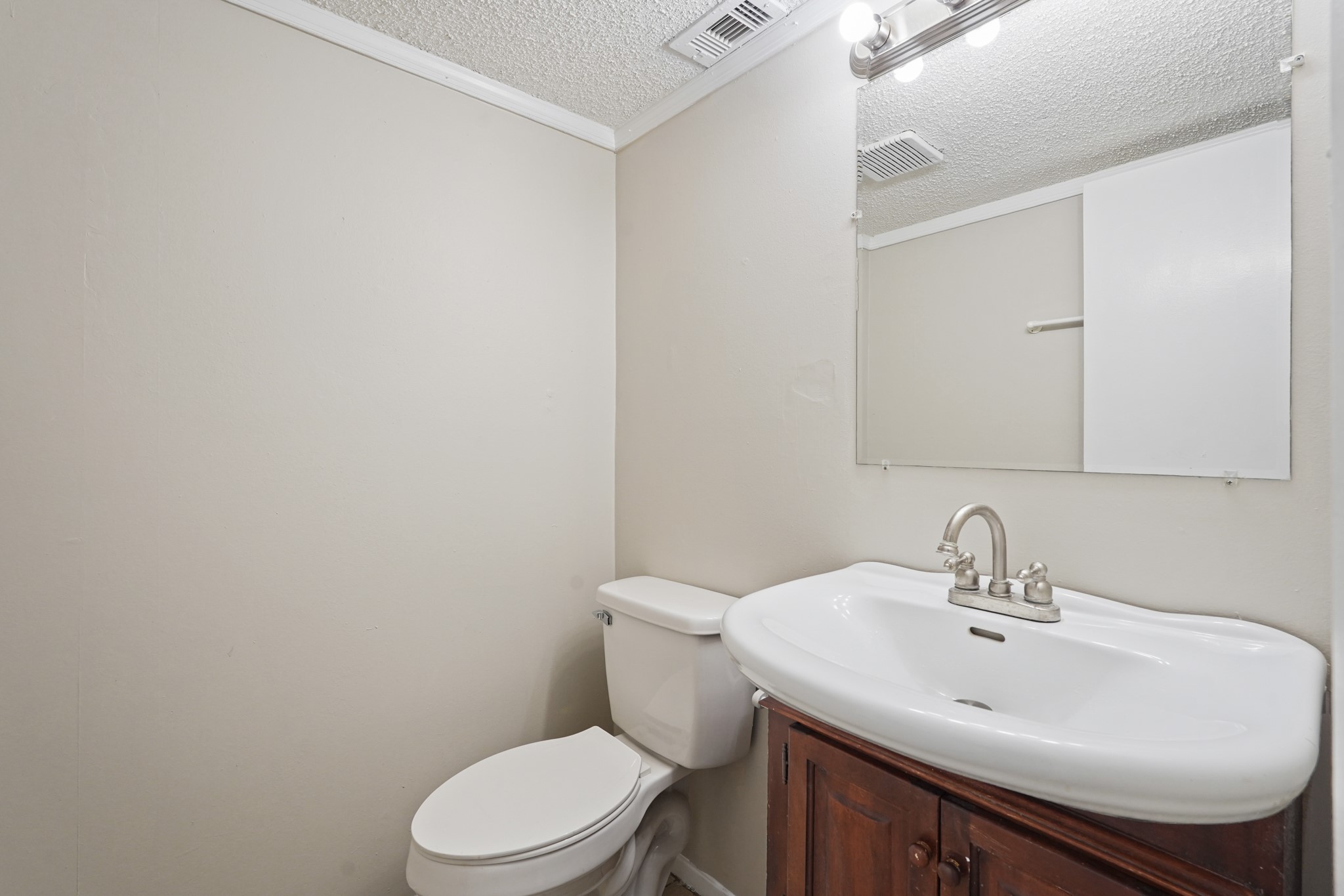 10328 Cook Road Houston, TX 77099 - Photo 4 of 16 a bathroom with a sink a toilet and mirror