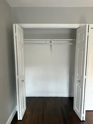 a view of closet with wooden floor
