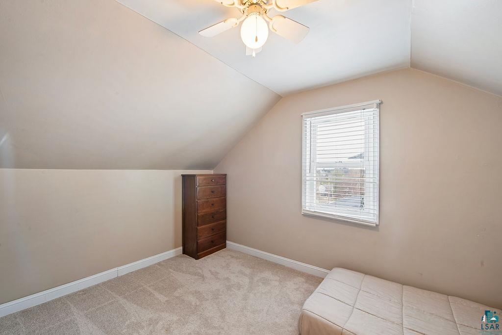 122 3rd Street Cloquet, MN 55720 - Photo 15 of 42 Carpeted room featuring a ceiling fan, sloped walls, a window with blinds, and white baseboards