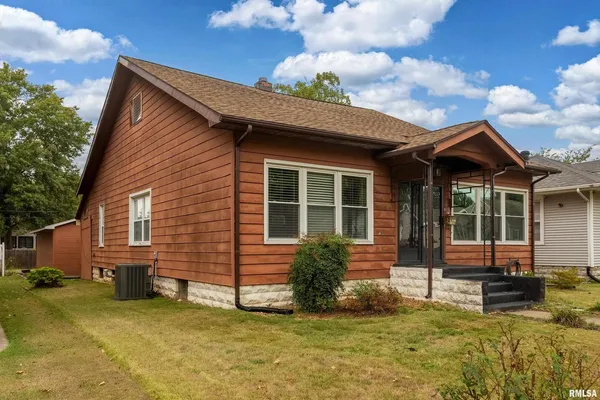 a view of a house with backyard porch and sitting area