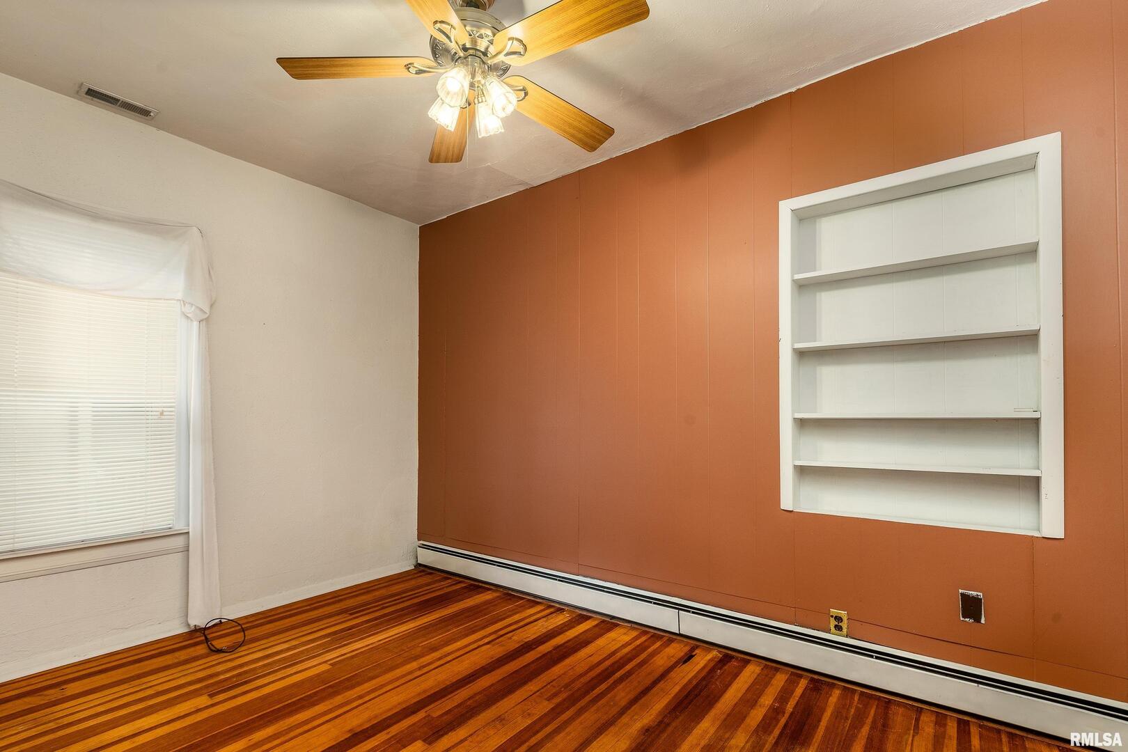 2120 Logan Street Murphysboro, IL 62966 - Photo 17 of 30 a view of an empty room with wooden floor and a window