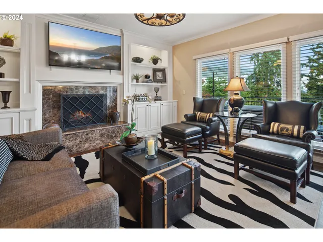 a kitchen with stainless steel appliances kitchen island granite countertop a stove a refrigerator a kitchen island a dining table and chairs with wooden floor