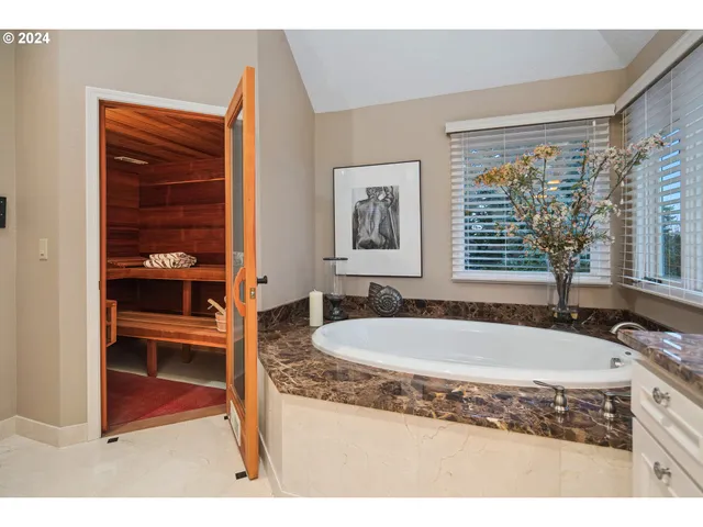 a bathroom with a shower sink and mirror