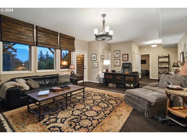 a living room with furniture a lamp and a large mirror