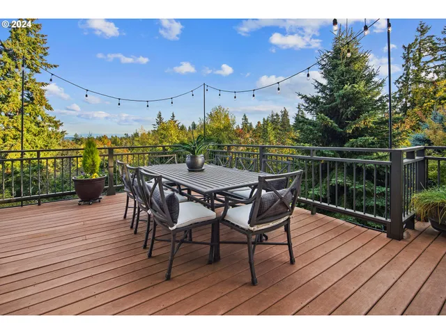 a view of a chairs and table on the wooden deck