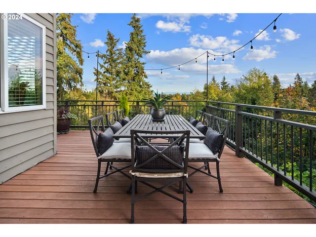 a view of a patio with couches table and chairs and potted plants