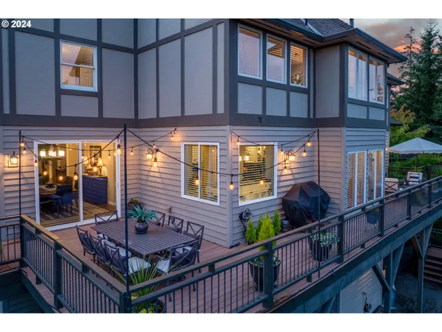 a front view of a house with a yard and potted plants