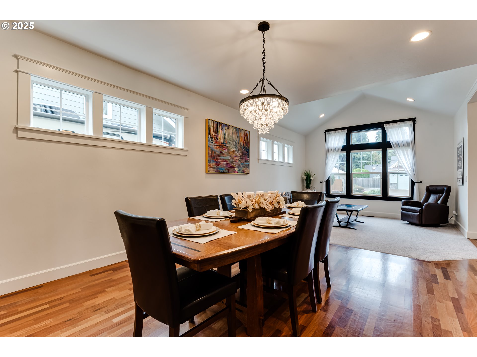 729 Aspen Street Springfield, OR 97477 - Photo 8 of 39 a view of a dining room and livingroom with furniture wooden floor a chandelier