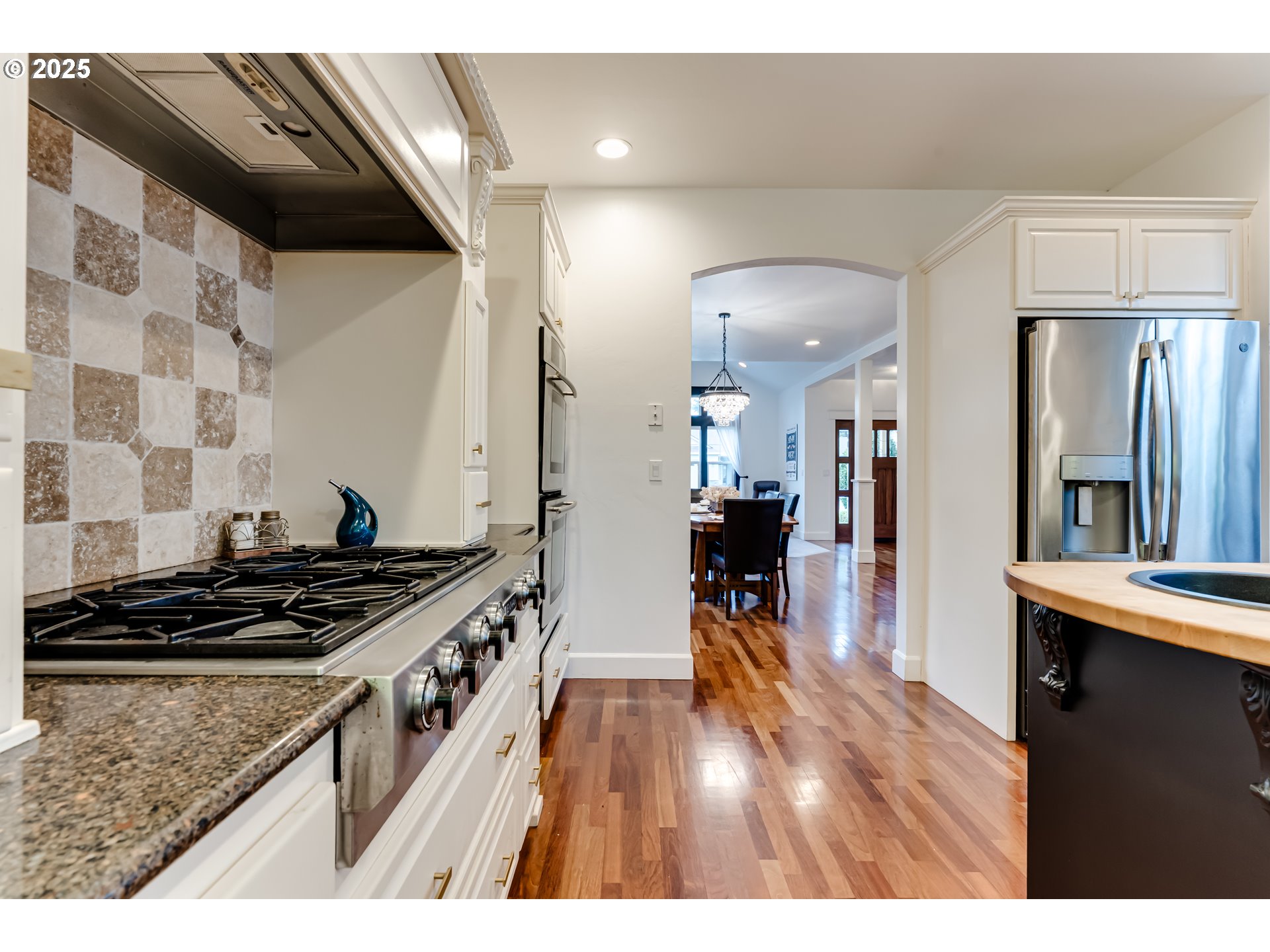 729 Aspen Street Springfield, OR 97477 - Photo 9 of 39 a kitchen with a stove and a wooden floor