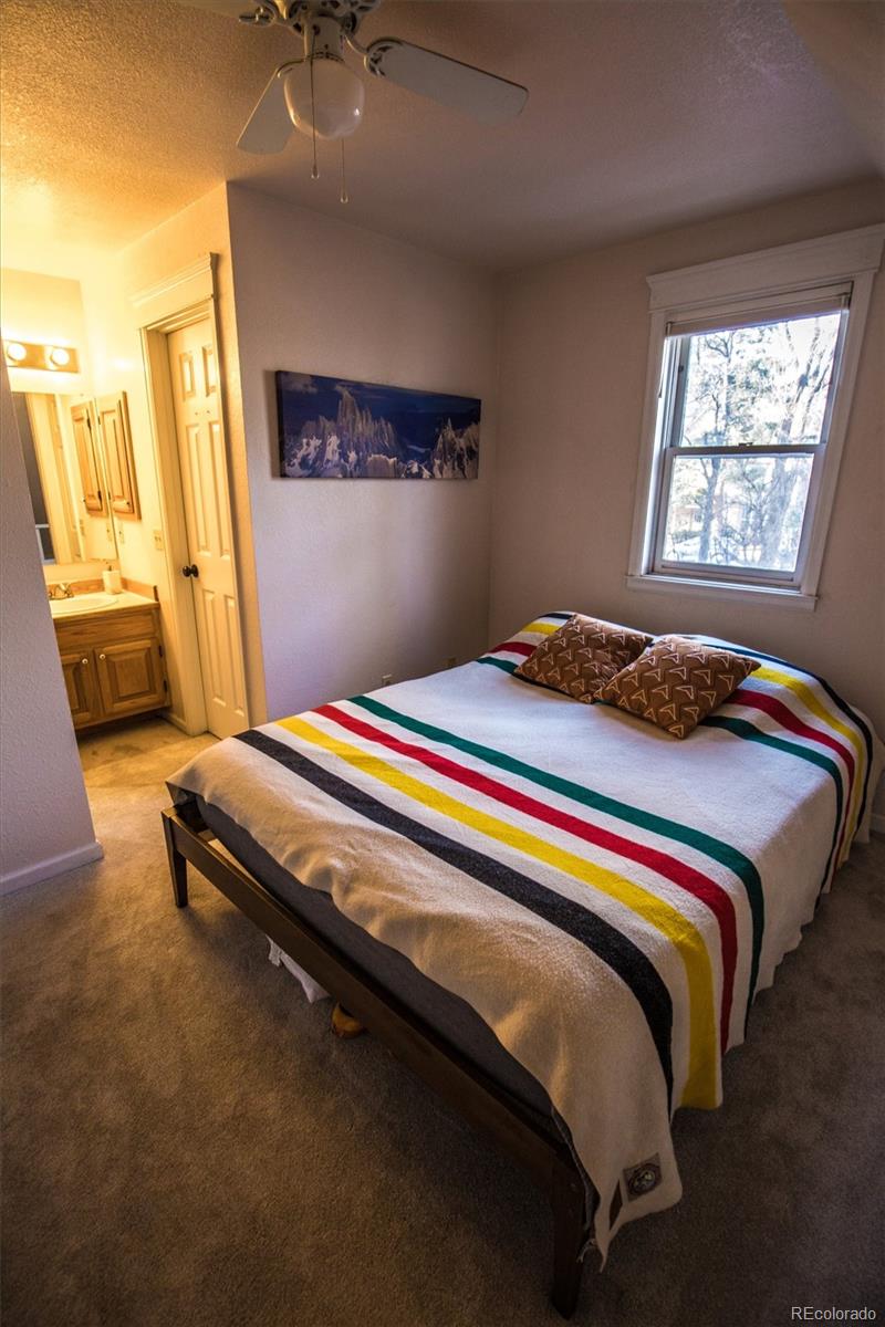 1430 18th Street, Unit 9 Boulder, CO 80302 - Photo 15 of 16 a bedroom with a bed and a window