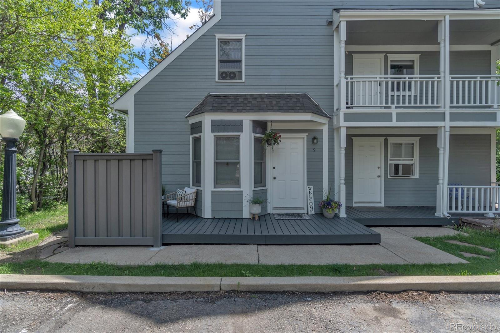 1430 18th Street, Unit 9 Boulder, CO 80302 - Photo 2 of 16 a front view of a house with a yard