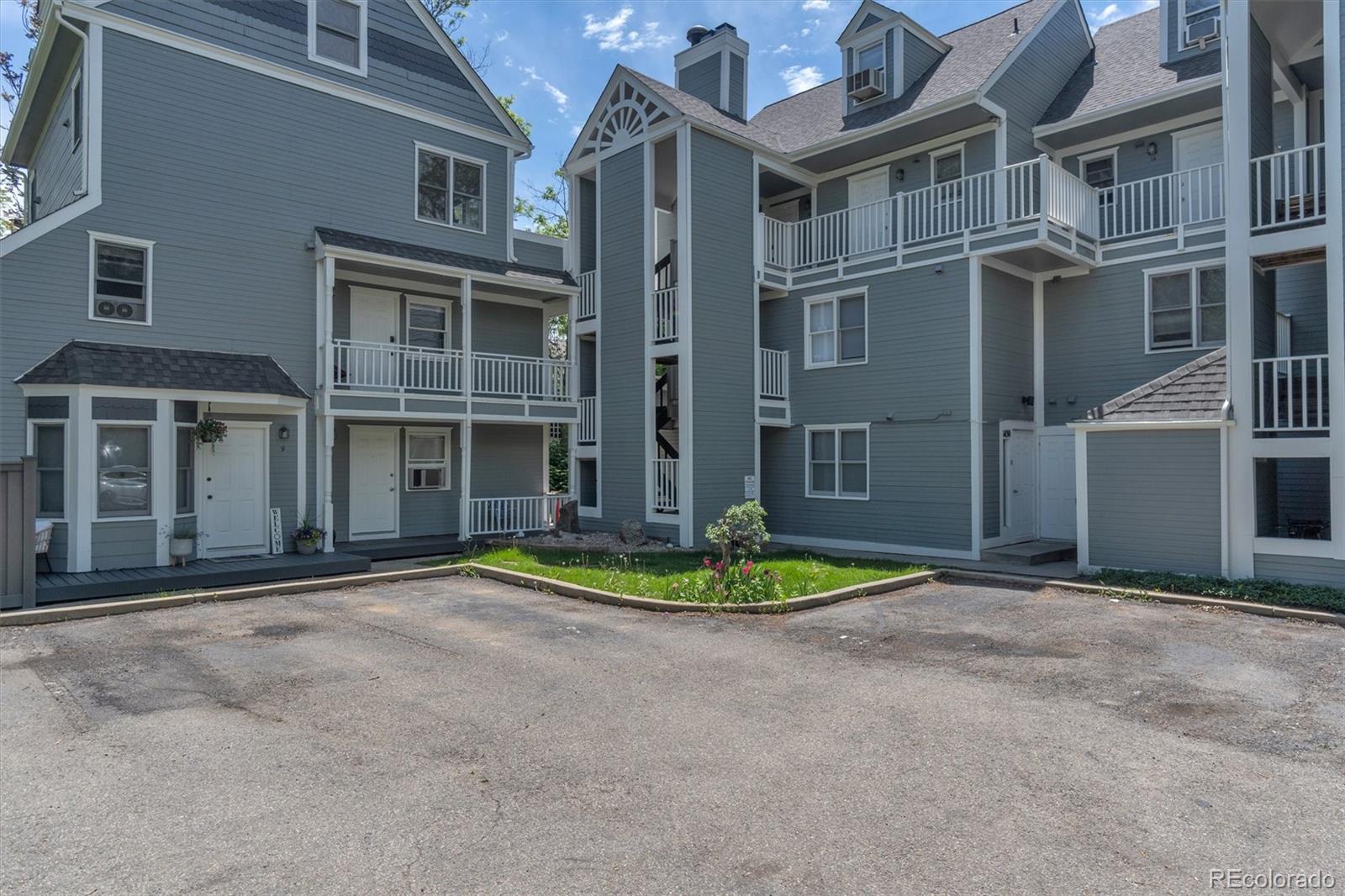 1430 18th Street, Unit 9 Boulder, CO 80302 - Photo 6 of 16 a front view of a residential apartment building with a yard