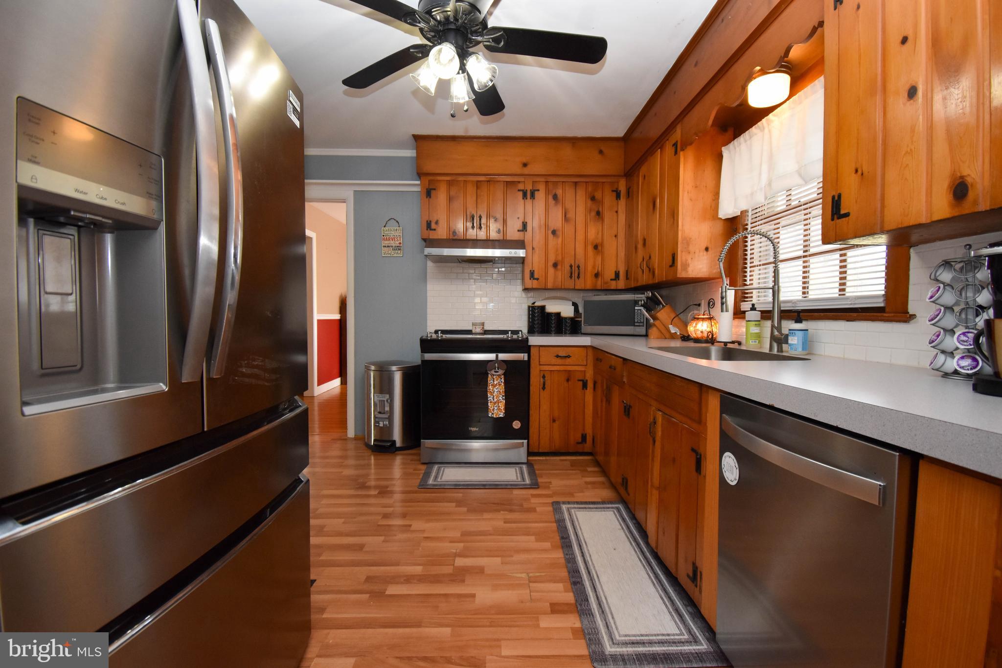 309 Robinson Street Georgetown, DE 19947 - Photo 11 of 26 a kitchen with stainless steel appliances granite countertop a stove a sink and a refrigerator
