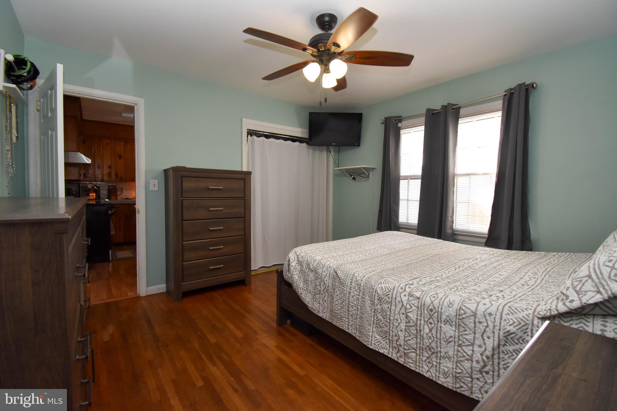 309 Robinson Street Georgetown, DE 19947 - Photo 12 of 26 a bedroom with a bed and a chandelier