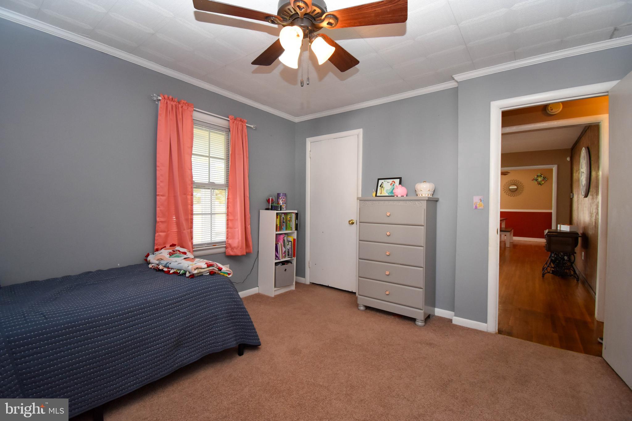 309 Robinson Street Georgetown, DE 19947 - Photo 17 of 26 a bedroom with a bed and a chandelier
