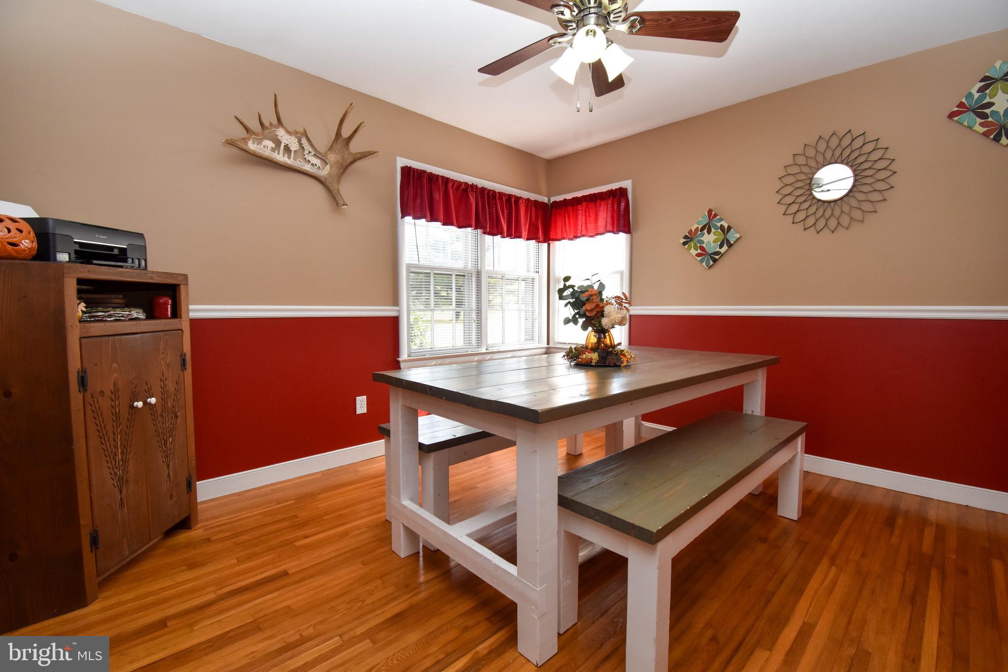 309 Robinson Street Georgetown, DE 19947 - Photo 7 of 26 a view of a dining room with furniture window and wooden floor