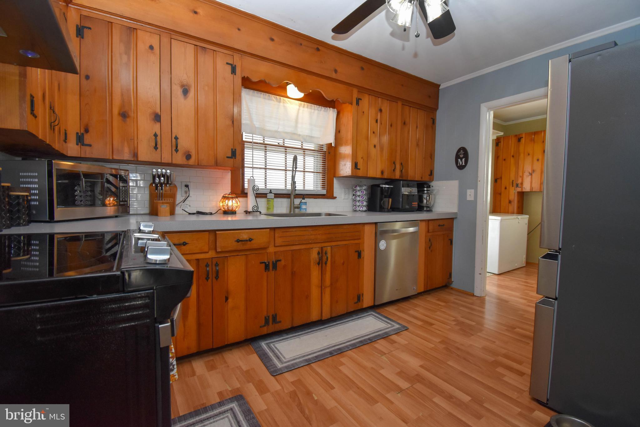309 Robinson Street Georgetown, DE 19947 - Photo 9 of 26 a kitchen with stainless steel appliances granite countertop a sink a stove and a refrigerator