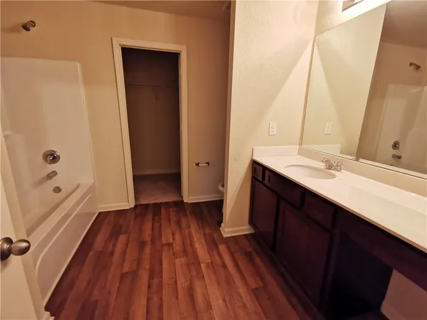 a bathroom with a sink a mirror and a toilet